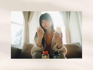 Woman taking vitamins and supplements together