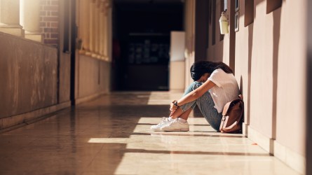 Anxious teen girl in school hallway