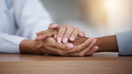 Hope, black woman or doctor holding hands in hospital consulting for medical test news or results for sympathy. Empathy, sad or zoom of nurse in healthcare clinic nursing or helping sick patient.