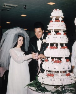 (Original Caption) Las Vegas, Nevada, Entertainer, Elvis Presley cuts wedding cake with his bride, the former Priscilla Ann Beaulieu, May 1, 1967.