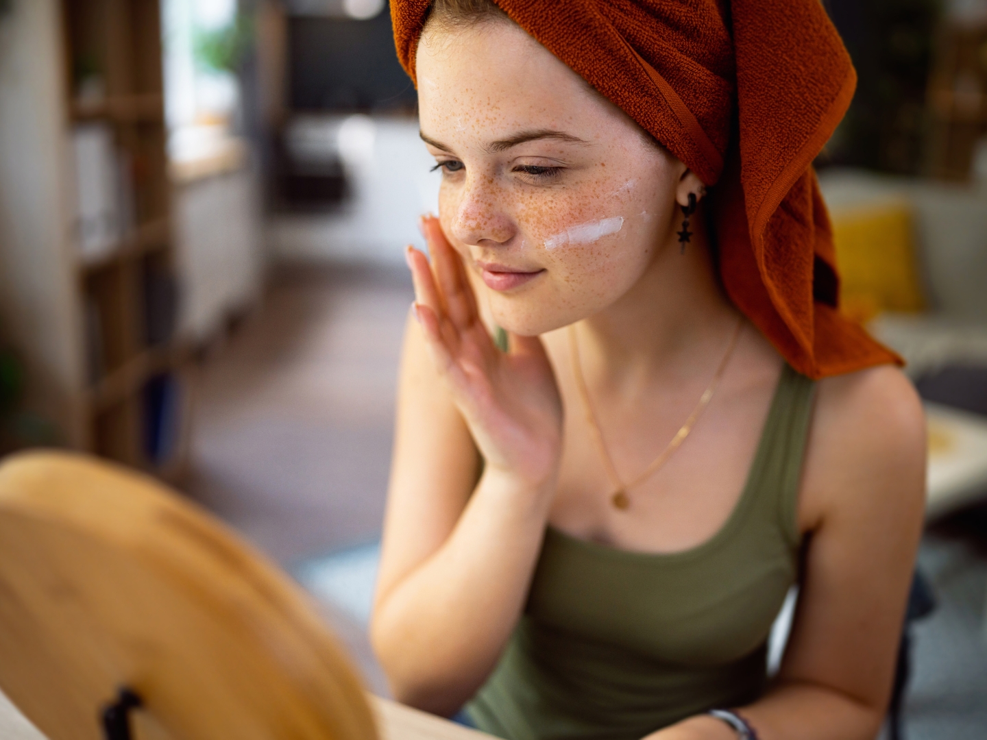 Teen girl applying skincare products